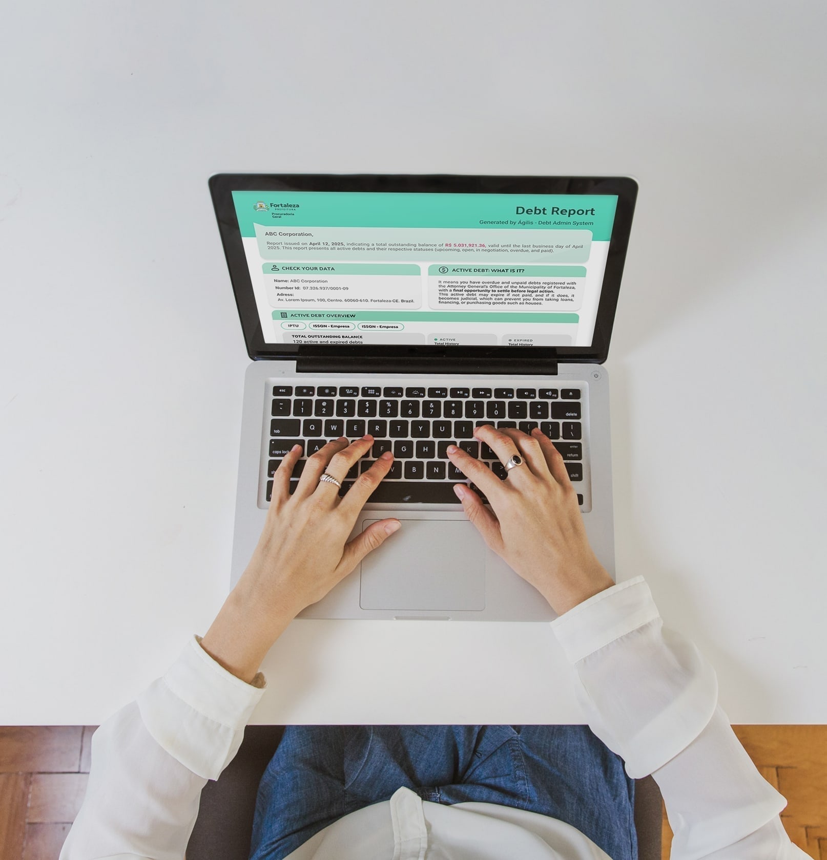 Person using the Debt Admin System on a laptop, showing a generated debt report